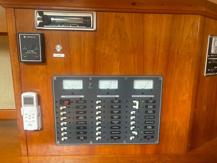Island Girl Yacht Photos Pics Electrical panel on a 1990 Island Packet 38 sailboat with various switches and meters.