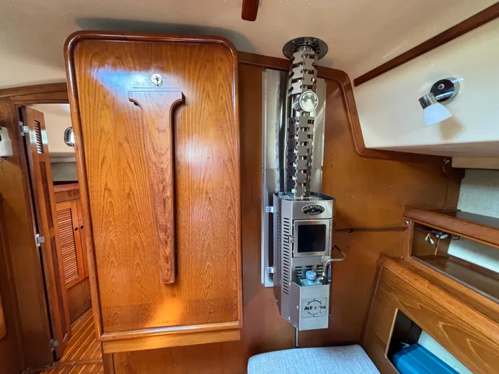 Island Girl Yacht Photos Pics Interior of 1990 Island Packet 38 sailboat with wooden cabinetry and compact heater.