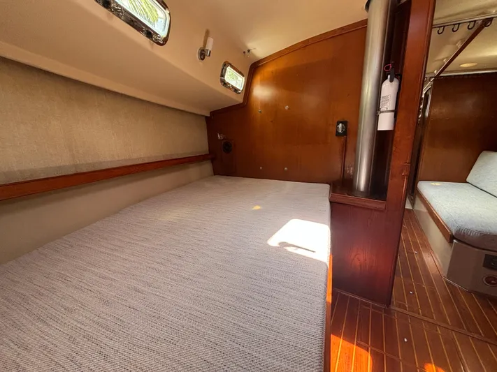 Island Girl Yacht Photos Pics 1990 Island Packet 38 interior cabin with wooden paneling and comfortable seating.