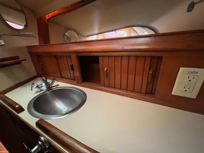 Island Girl Yacht Photos Pics 1990 Island Packet 38 yacht interior with wooden cabinets and stainless steel sink.