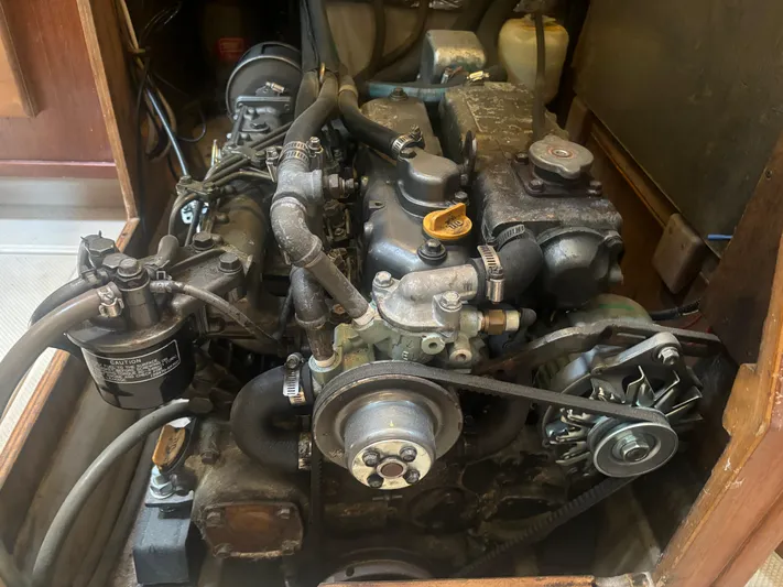 Island Girl Yacht Photos Pics Engine of a 1990 Island Packet 38 sailboat, showcasing mechanical components and belts.