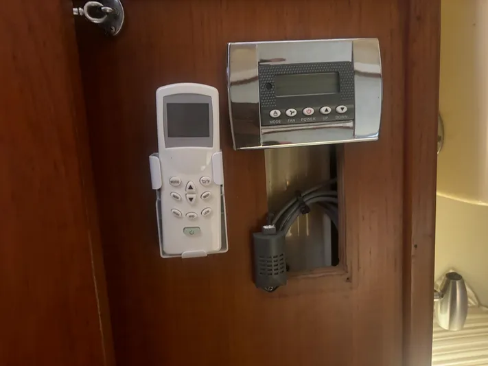 Island Girl Yacht Photos Pics Control panel and remote on Island Packet 38 yacht, 1990 model, mounted on wooden surface.