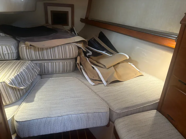 Island Girl Yacht Photos Pics Interior cabin of 1990 Island Packet 38 sailboat with striped cushions.