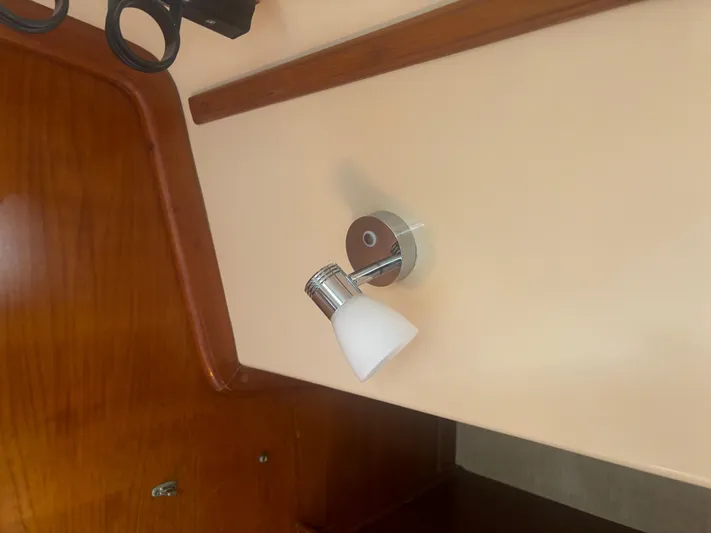 Island Girl Yacht Photos Pics Wall-mounted light fixture inside 1990 Island Packet 38 sailboat cabin.