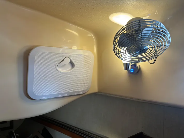 Island Girl Yacht Photos Pics Interior of 1990 Island Packet 38 yacht with fan and vent on wall.