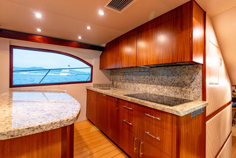 Baja Vida Yacht Photos Pics Luxurious kitchen interior of 2010 Hatteras 60 Convertible yacht with granite countertops.