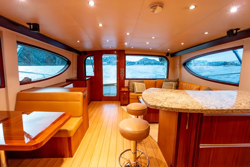 Baja Vida Yacht Photos Pics Luxurious interior of 2010 Hatteras 60 Convertible yacht with elegant seating and panoramic windows.