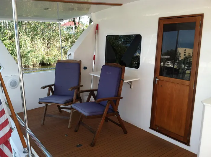 The Harlen Wood Yacht Photos Pics Deck of 2010 Shannon 53 HPS yacht with two chairs and wooden door.