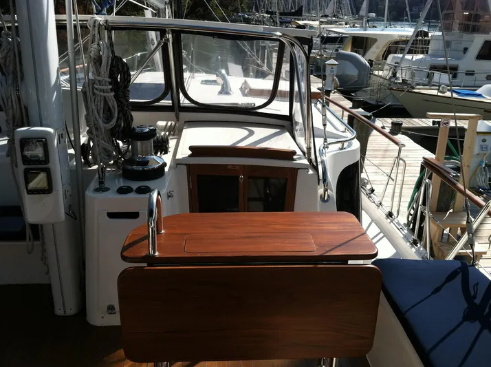 The Harlen Wood Yacht Photos Pics Cockpit of 2010 Shannon 53 HPS yacht with wooden table and marina view.