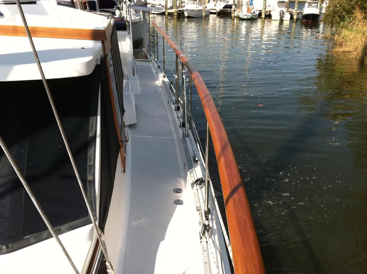 The Harlen Wood Yacht Photos Pics 2010 Shannon 53 HPS yacht deck with wooden railing, docked in marina.