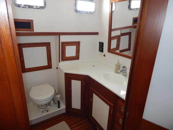 The Harlen Wood Yacht Photos Pics Luxurious bathroom in 2010 Shannon 53 HPS yacht with wooden cabinetry and modern fixtures.