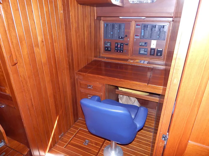 The Harlen Wood Yacht Photos Pics Wood-paneled navigation station with blue chair on 2010 Shannon 53 HPS yacht.