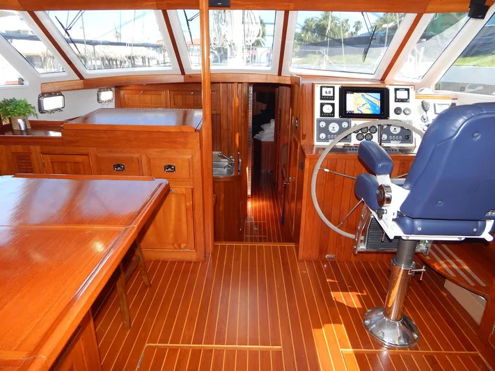 The Harlen Wood Yacht Photos Pics Luxurious 2010 Shannon 53 HPS yacht interior with polished wood and modern navigation equipment.