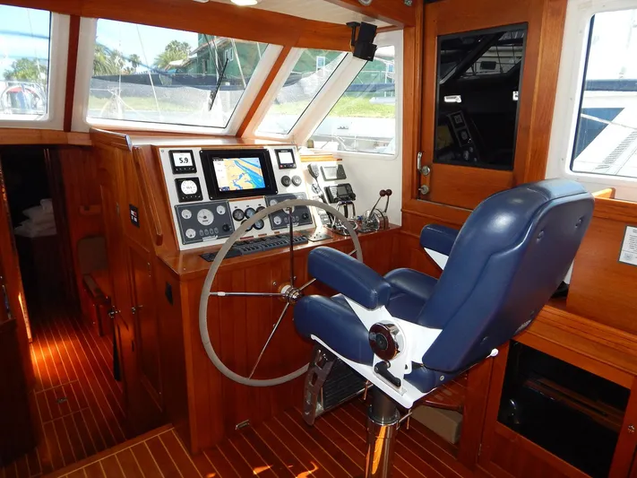 The Harlen Wood Yacht Photos Pics Helm of 2010 Shannon 53 HPS yacht with navigation equipment and blue captain's chair.