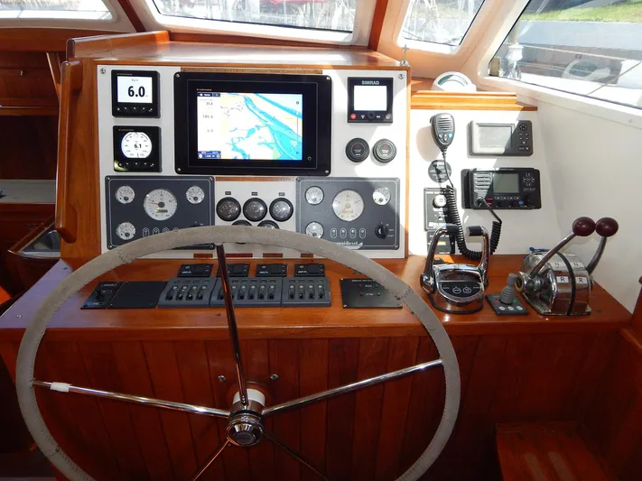 The Harlen Wood Yacht Photos Pics Helm of 2010 Shannon 53 HPS yacht with navigation instruments and wooden steering wheel.