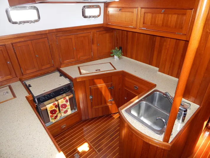 The Harlen Wood Yacht Photos Pics Luxurious wooden kitchen interior of 2010 Shannon 53 HPS yacht with modern amenities.