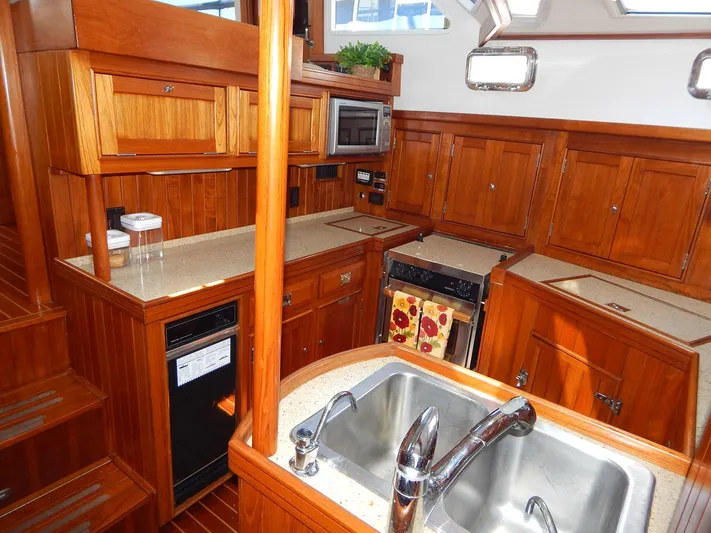 The Harlen Wood Yacht Photos Pics Luxurious wooden kitchen interior of 2010 Shannon 53 HPS yacht with modern amenities.