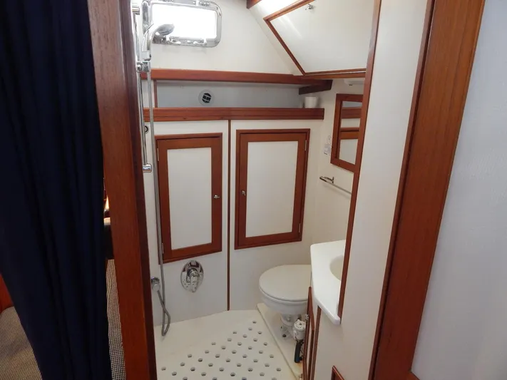 The Harlen Wood Yacht Photos Pics Bathroom interior of 2010 Shannon 53 HPS yacht, featuring wood accents and compact design.
