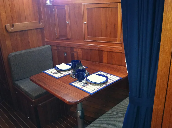 The Harlen Wood Yacht Photos Pics Cozy dining area in 2010 Shannon 53 HPS yacht with wooden interior and table settings.