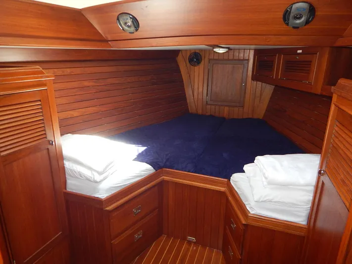 The Harlen Wood Yacht Photos Pics Cozy wooden cabin interior of 2010 Shannon 53 HPS yacht with bed and storage.