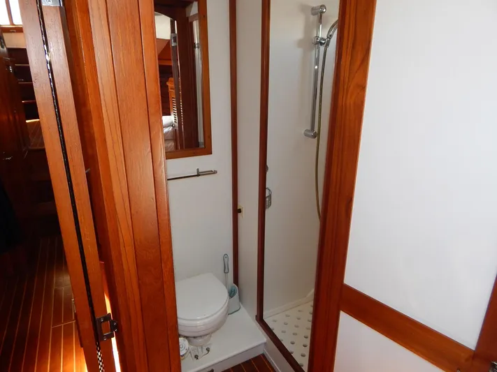 The Harlen Wood Yacht Photos Pics Compact bathroom with wooden accents on a 2010 Shannon 53 HPS yacht.