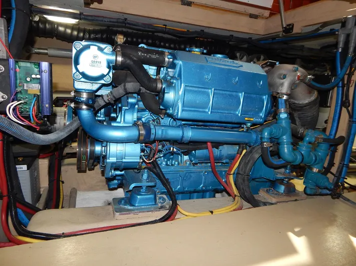 The Harlen Wood Yacht Photos Pics Engine of a 2010 Shannon 53 HPS boat, featuring blue components and various hoses.