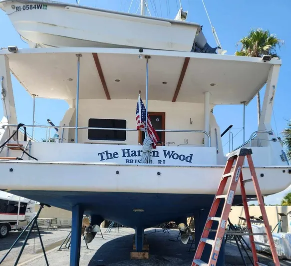 The Harlen Wood Yacht Photos Pics Shannon 53 HPS yacht, 2010 model, on dry dock with American flag and ladder.