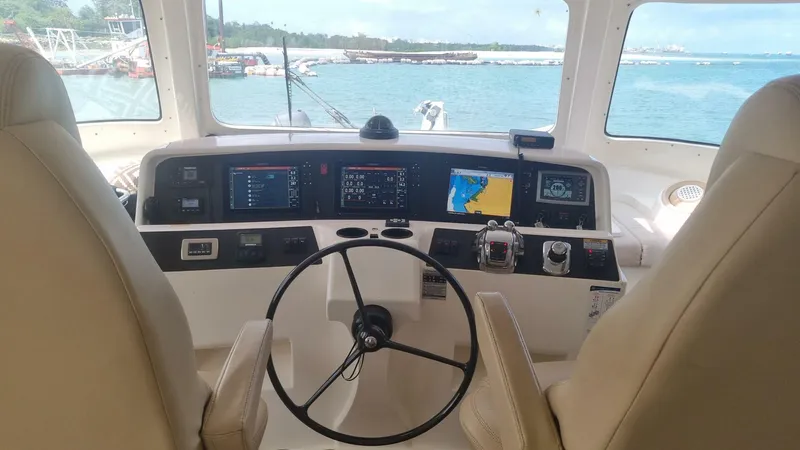 Albatross Yacht Photos Pics 2014 PowerPlay Catamarans Power Cat helm with navigation screens and ocean view.