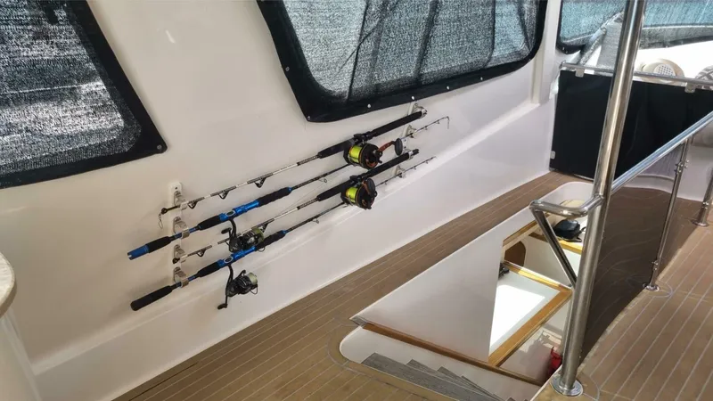 Albatross Yacht Photos Pics 2014 PowerPlay Catamarans Power Cat interior with fishing rods mounted on the wall.