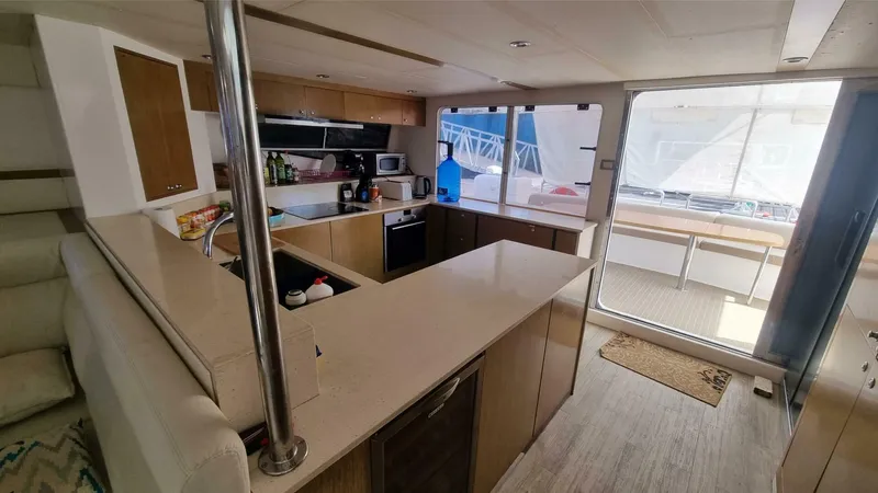 Albatross Yacht Photos Pics 2014 PowerPlay Catamarans Power Cat interior kitchen with modern amenities and ample counter space.