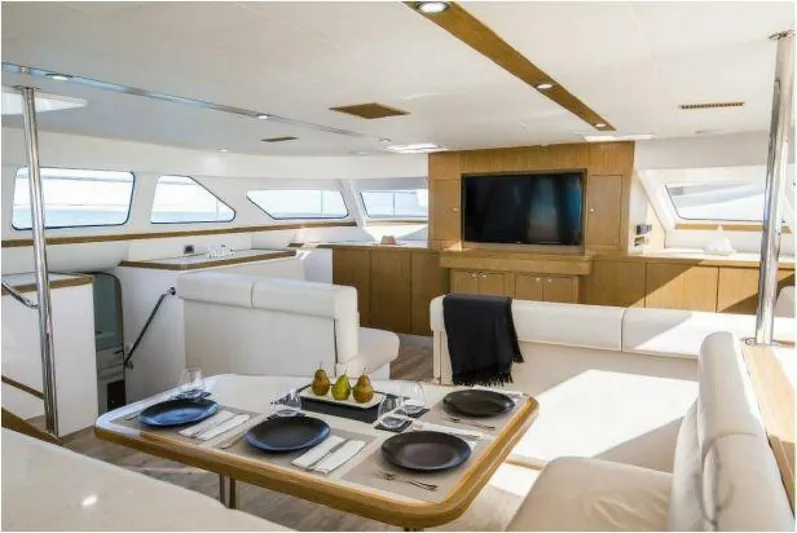 Albatross Yacht Photos Pics Luxurious interior of 2014 PowerPlay Catamarans Power Cat with modern furnishings and dining area.