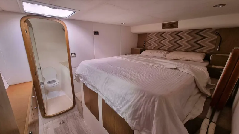 Albatross Yacht Photos Pics 2014 PowerPlay Catamarans Power Cat bedroom with ensuite bathroom, featuring a cozy bed and modern design.