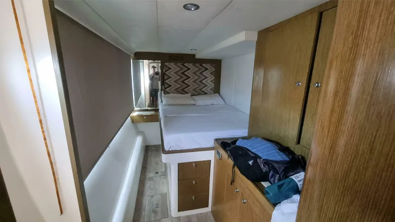 Albatross Yacht Photos Pics Cozy cabin interior of 2014 PowerPlay Catamarans Power Cat with bed and storage.
