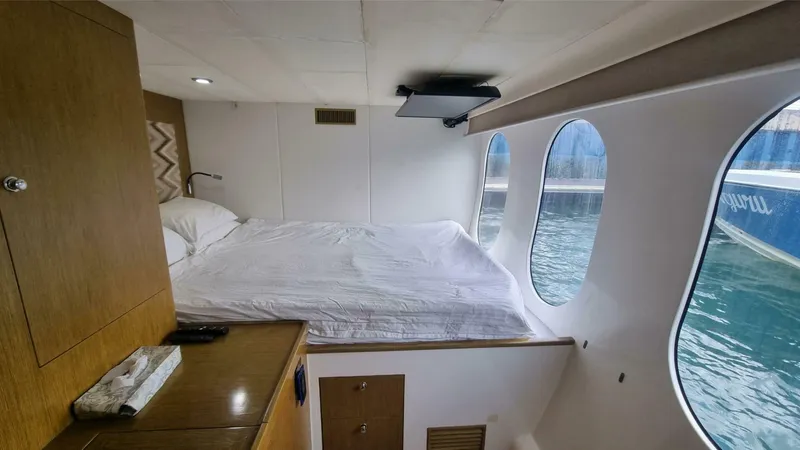Albatross Yacht Photos Pics Cozy cabin interior of 2014 PowerPlay Catamarans Power Cat with waterfront view.
