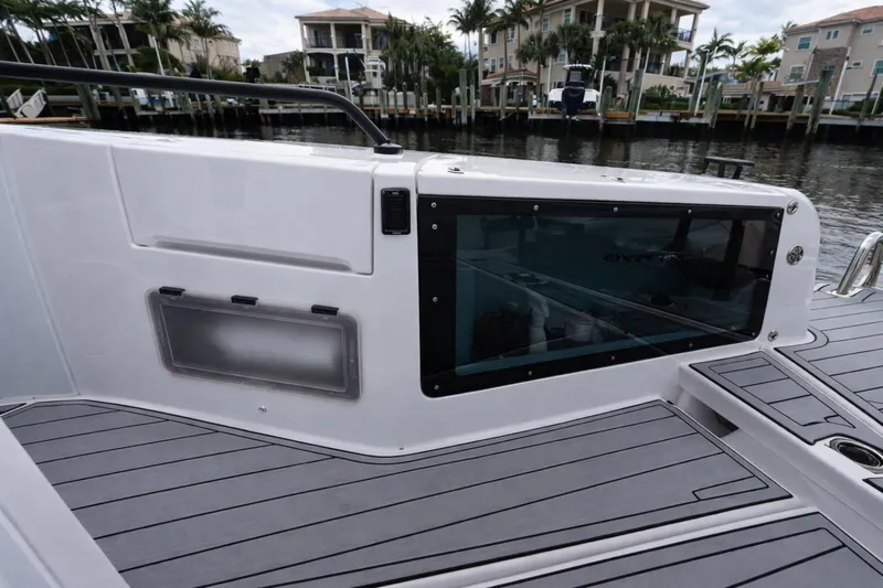  Yacht Photos Pics 2022 Axopar 37 Sun-Top boat deck with sleek design and waterfront view.
