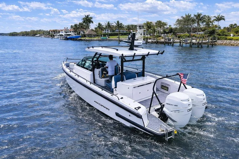  Yacht Photos Pics 2022 Axopar 37 Sun-Top boat cruising on a sunny day with twin Mercury engines.