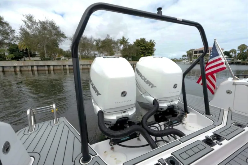  Yacht Photos Pics 2022 Axopar 37 Sun-Top with dual Mercury engines, docked by a waterfront.