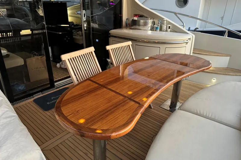 Victoria Yacht Photos Pics Luxurious 2007 Azimut 68S yacht deck with polished wooden table and seating area.