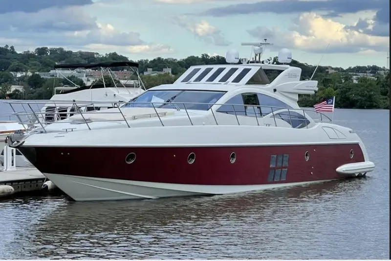 Victoria Yacht Photos Pics 2007 Azimut 68S yacht docked on a serene lake under a cloudy sky.