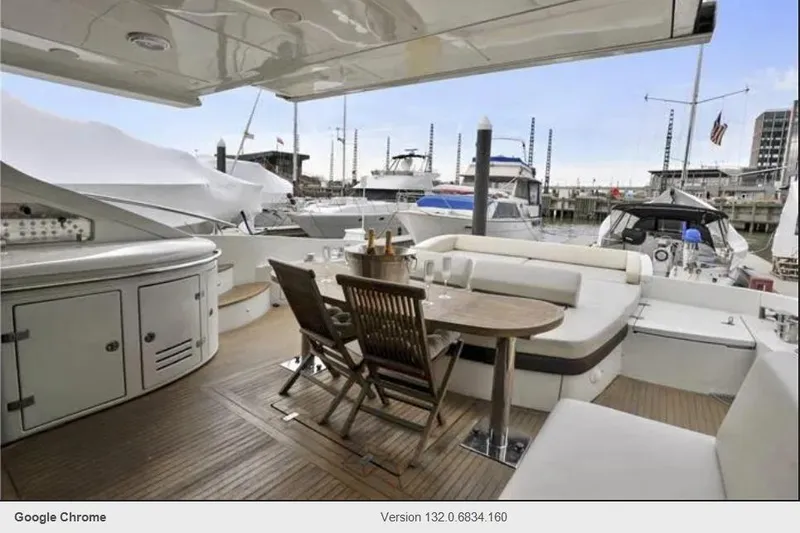 Victoria Yacht Photos Pics Luxurious 2007 Azimut 68S yacht deck with seating and table, docked at marina.