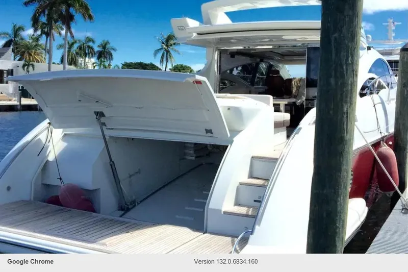 Victoria Yacht Photos Pics 2007 Azimut 68S yacht docked, open rear hatch, palm trees in background.