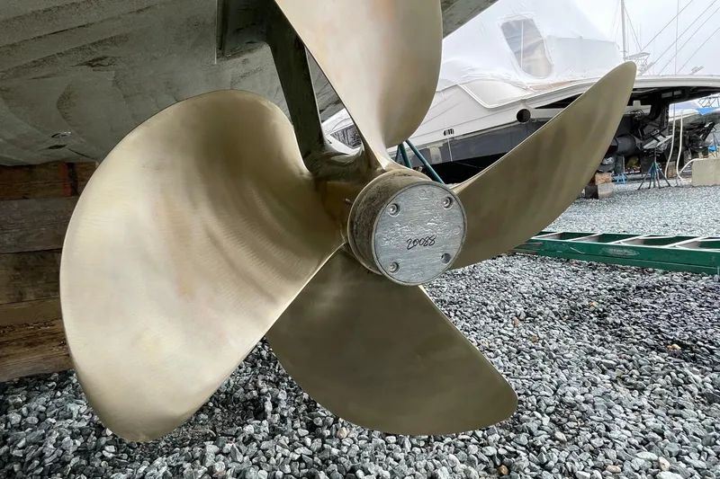 Victoria Yacht Photos Pics Close-up of a 2007 Azimut 68S yacht propeller on gravel surface.