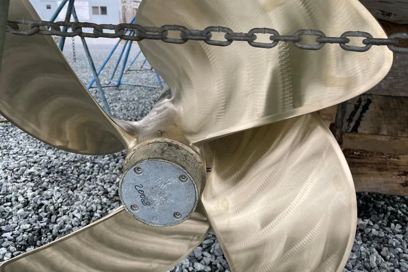 Victoria Yacht Photos Pics Close-up of a 2007 Azimut 68S yacht propeller on gravel surface.