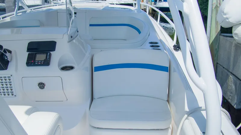 R&r Yacht Photos Pics 2017 Intrepid 400 Cuddy boat interior with white and blue seating, control panel, and cup holders.