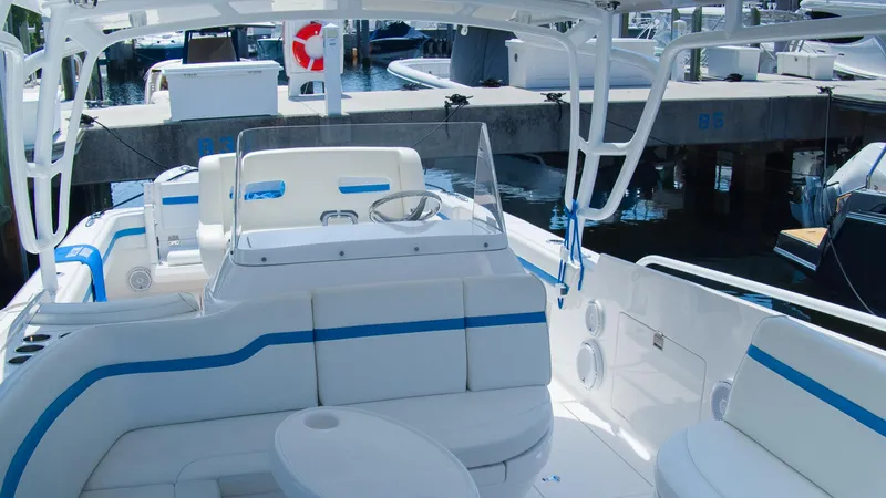 R&r Yacht Photos Pics 2017 Intrepid 400 Cuddy boat interior with white and blue seating at marina.