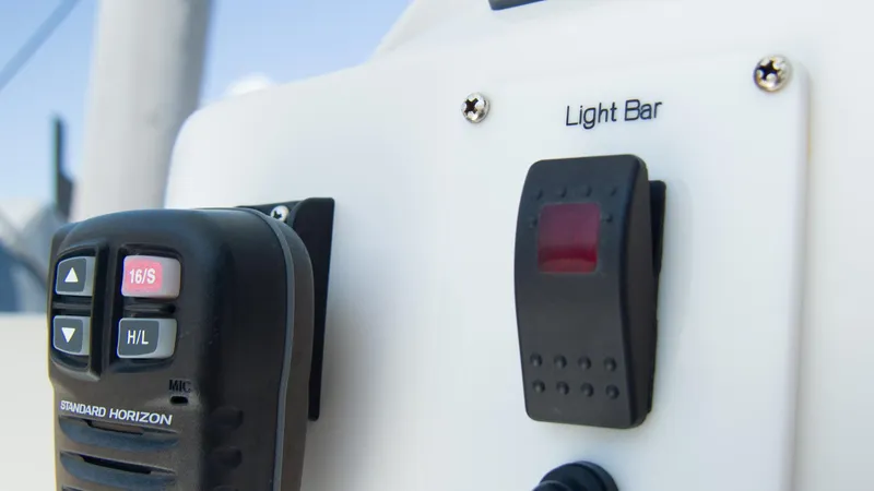 R&r Yacht Photos Pics Close-up of control panel on 2017 Intrepid 400 Cuddy boat, featuring light bar switch and Standard Horizon mic.