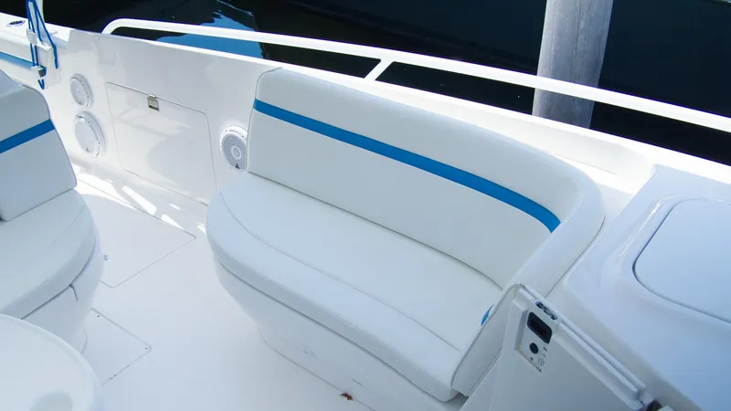 R&r Yacht Photos Pics 2017 Intrepid 400 Cuddy boat interior seating area with white and blue cushioned seats.