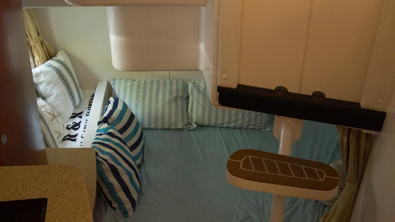 R&r Yacht Photos Pics Interior cabin of 2017 Intrepid 400 Cuddy with striped pillows and bedding.