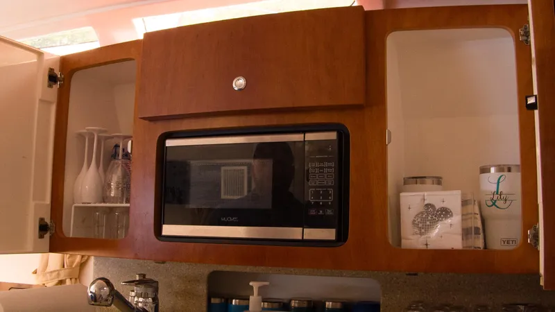 R&r Yacht Photos Pics 2017 Intrepid 400 Cuddy kitchen with microwave, glassware, and storage cabinets.