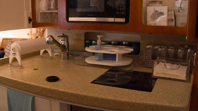 R&r Yacht Photos Pics 2017 Intrepid 400 Cuddy kitchen area with sink, microwave, and countertop accessories.